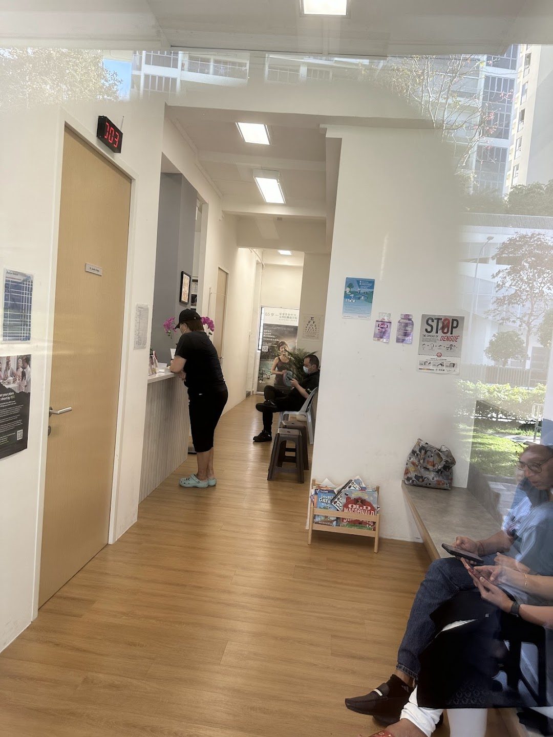 JustCare Medical clinic interior — bright, clean waiting area with warm timber flooring